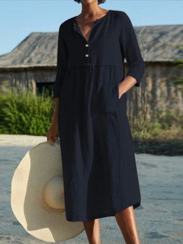 Black midi dress with buttons made of premium nori material. Features functional pockets for practicality. Classic and…