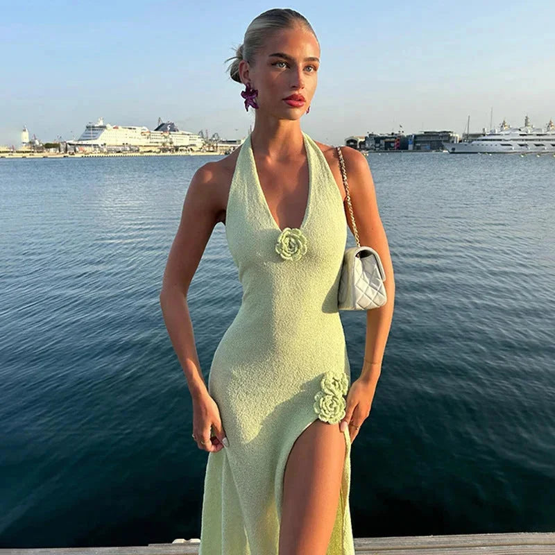 Green halter neck maxi dress with side slit. Made of soft, flowy fabric perfect for casual or formal occasions.