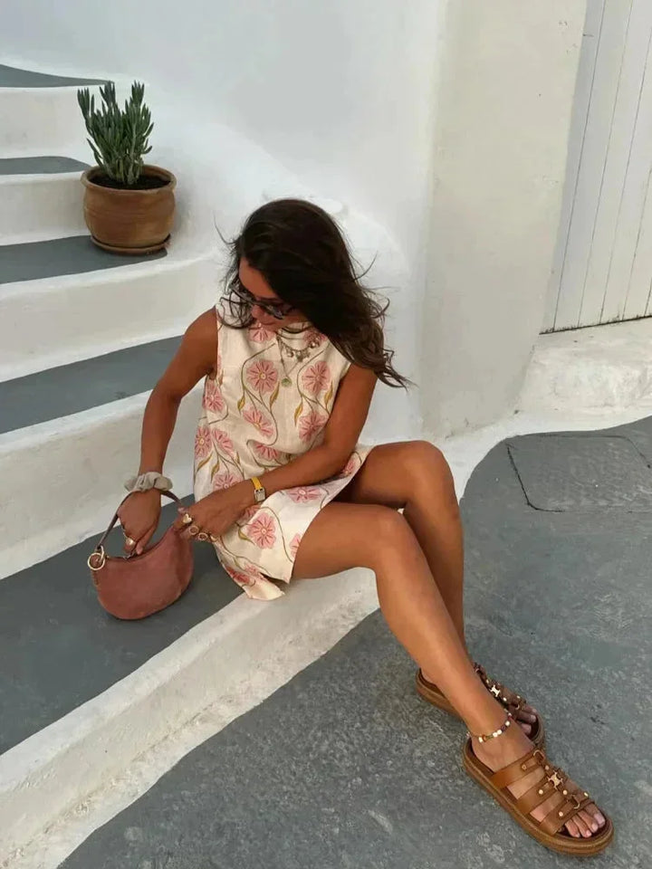 "Sleeveless pink floral dress for women, made of soft fabric with a charming and elegant design perfect for any occasion."