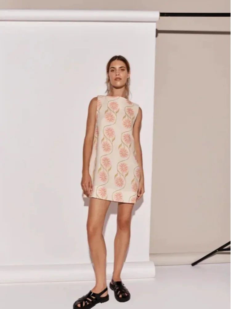 Women's pink floral print sleeveless dress with a vibrant design, flattering fit, and soft cotton fabric perfect for summer…