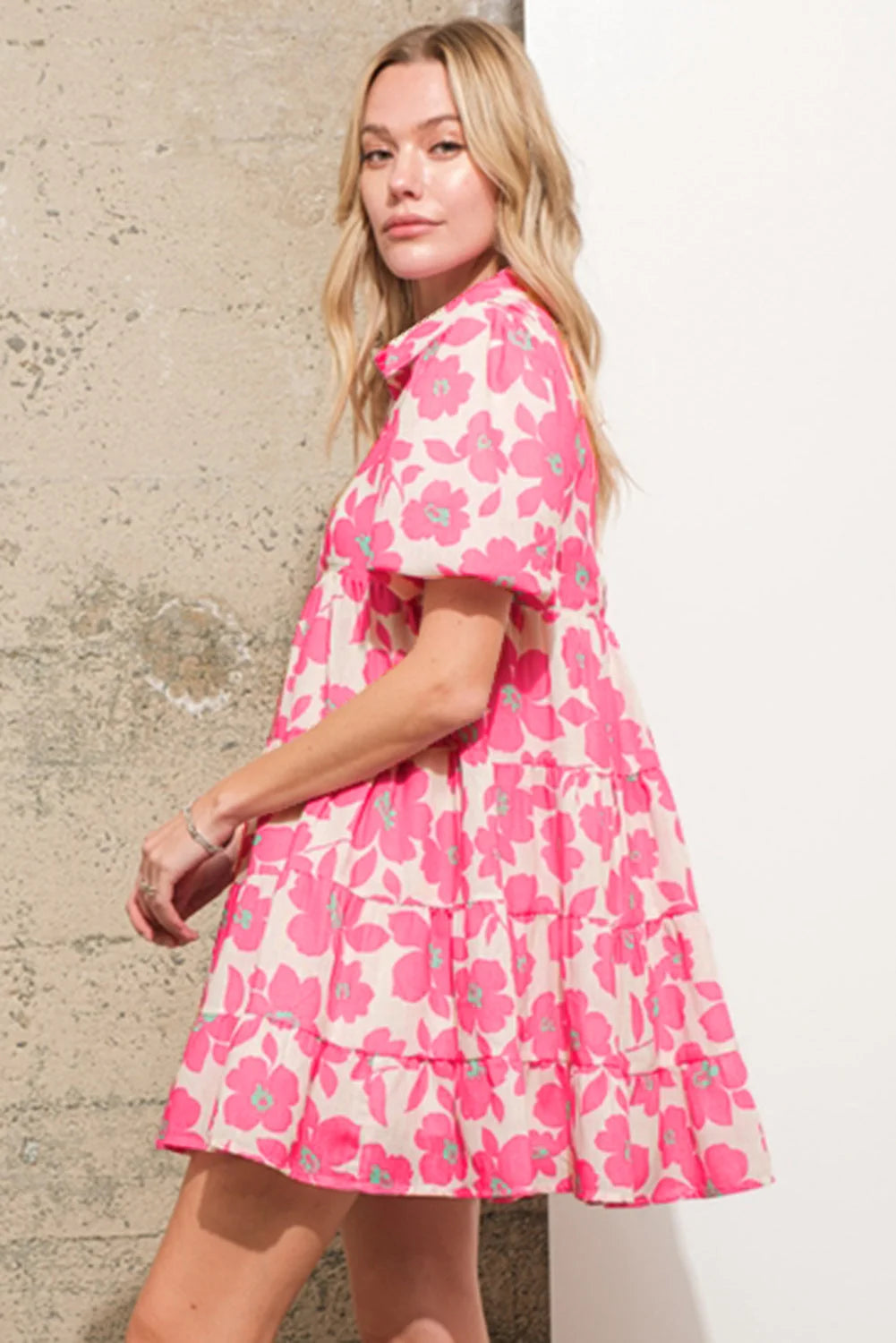 Pink tiered shirt dress featuring a charming floral print. Perfect for a casual yet stylish look.