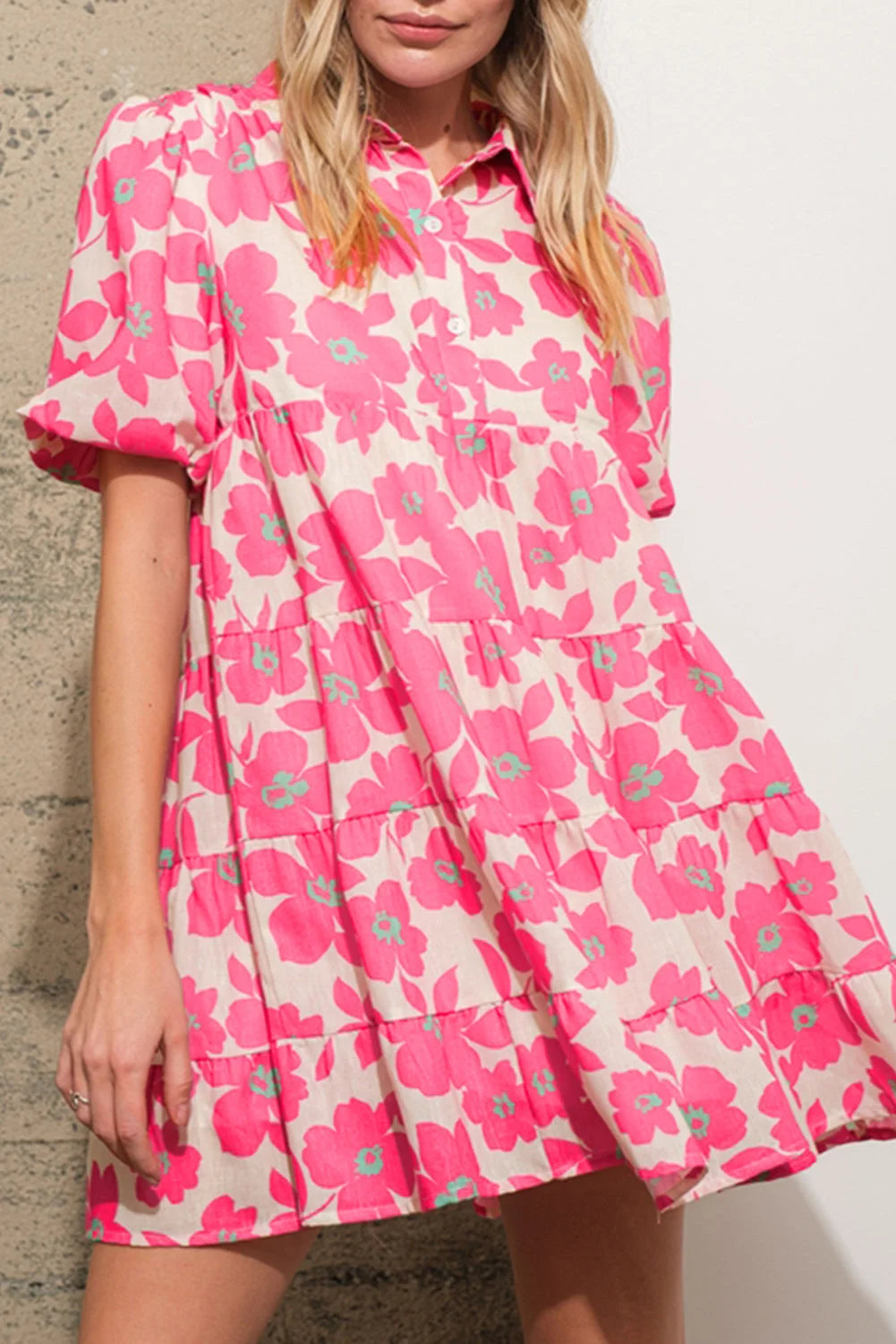 Pink shirt dress with tiered style, featuring a charming floral print. Perfect for a casual yet standout look.