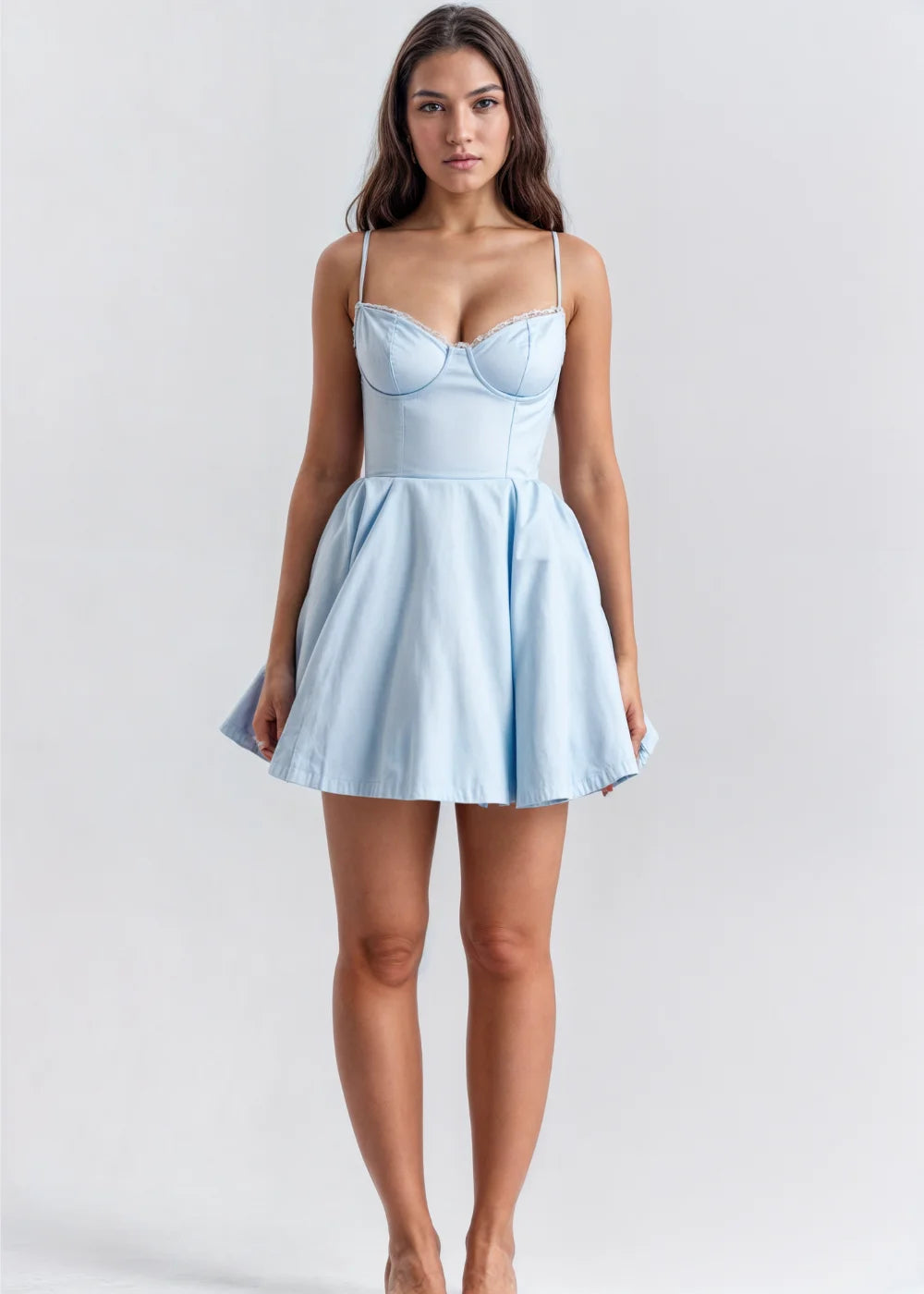 Blue spaghetti strap dress with a flared skirt. Made of soft, flowing fabric. Perfect for a casual yet stylish look.