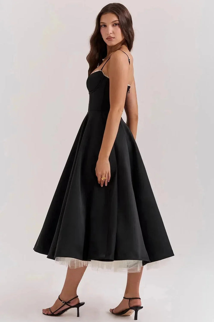 "Black satin dress with cream tulle hem, perfect for a sophisticated and elegant look."