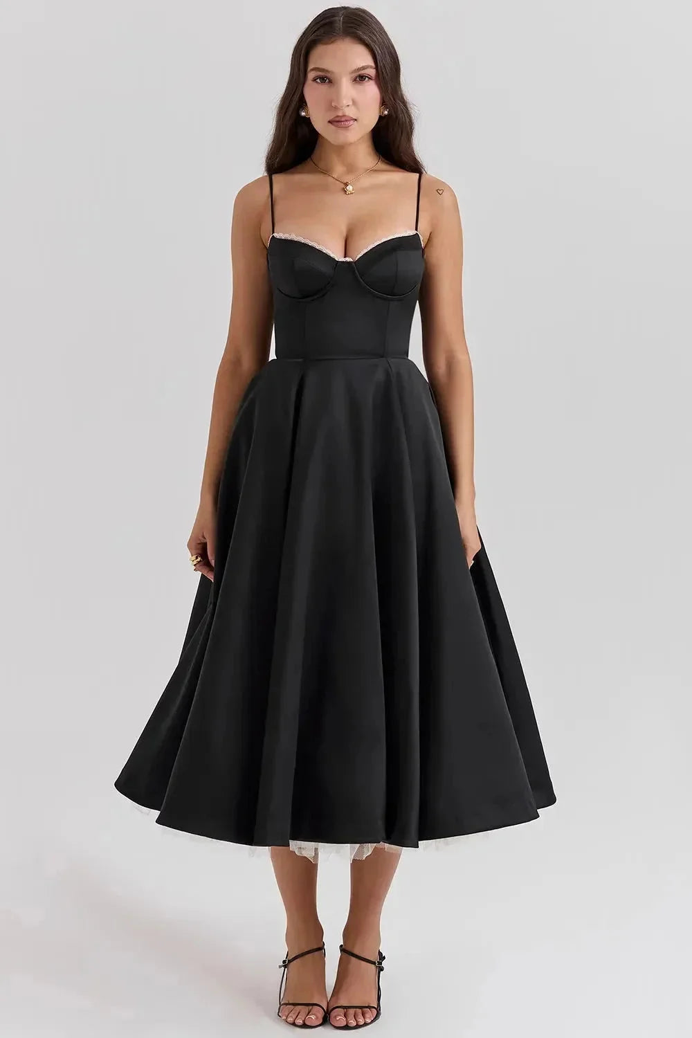 Black satin dress with cream tulle hem, elegant and sultry. Features strapless design, sweetheart neckline, and delicate…