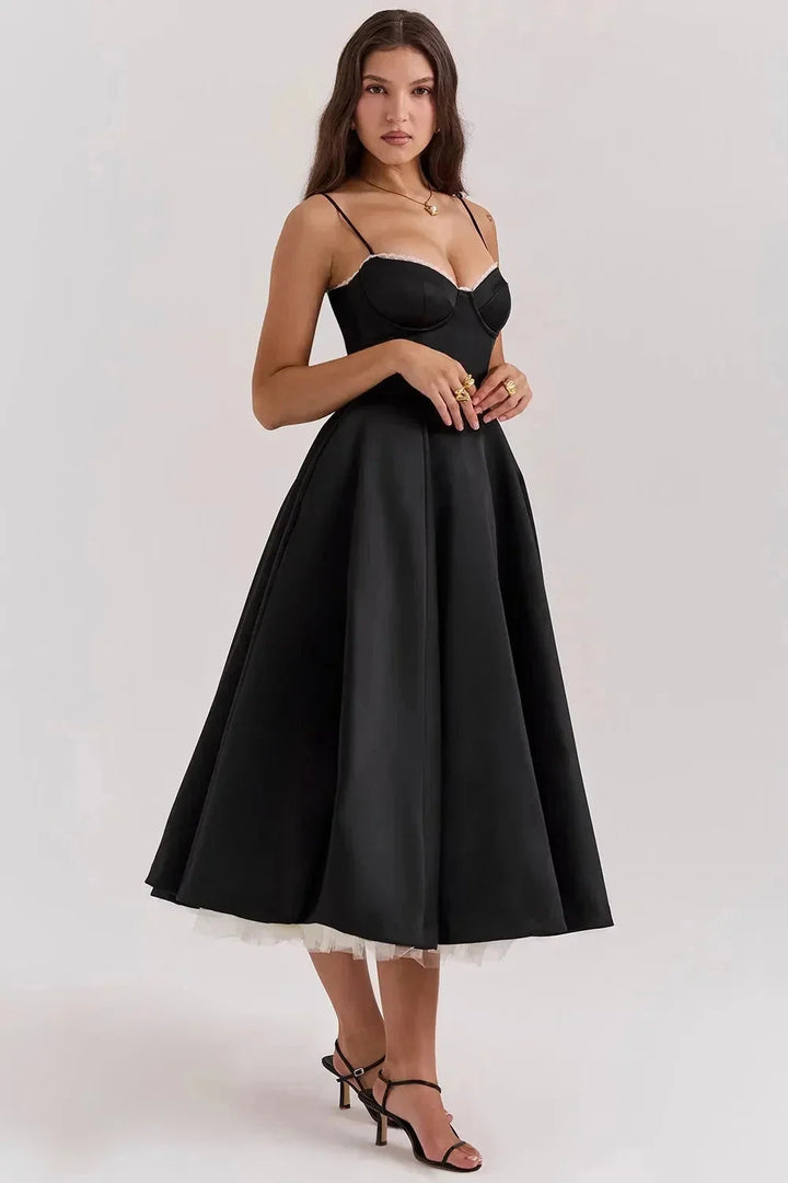 Black satin dress with cream tulle hem, elegant and chic design for special occasions.