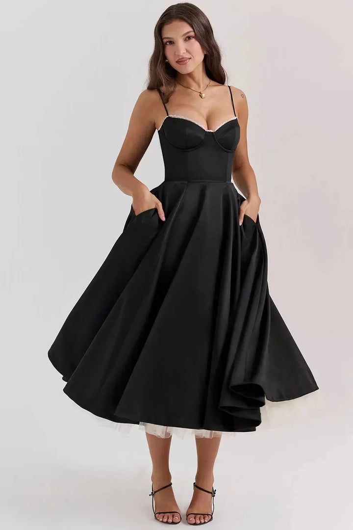"Black satin dress with cream tulle hem, elegant and sophisticated design for formal occasions."
