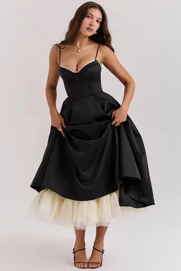 "Black satin dress with cream tulle hem featuring a classic and elegant design, perfect for special occasions."