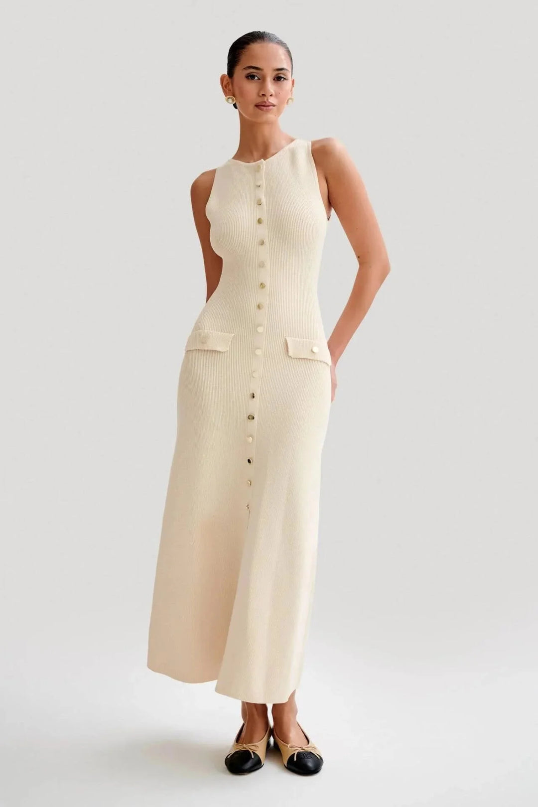 Apricot sleeveless dress with front buttons, chic and elegant design for modern fashionista, perfect for casual or special…