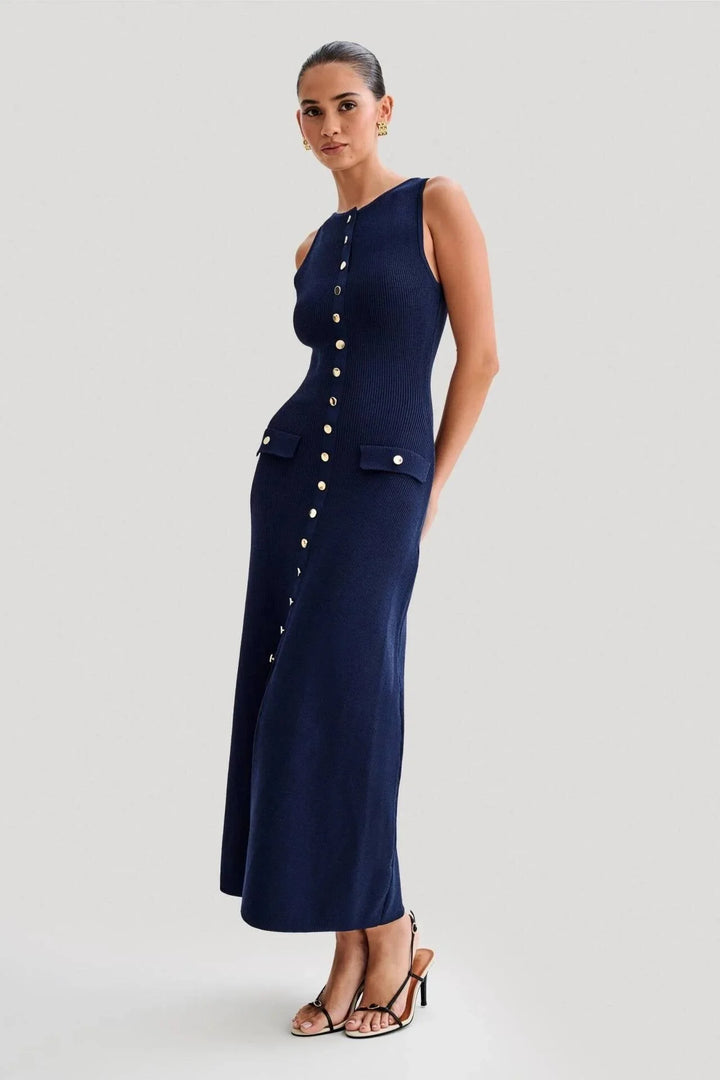 Blue sleeveless dress with front buttons. Features a sleek design, made from high-quality fabric. Ideal for day-to-night…