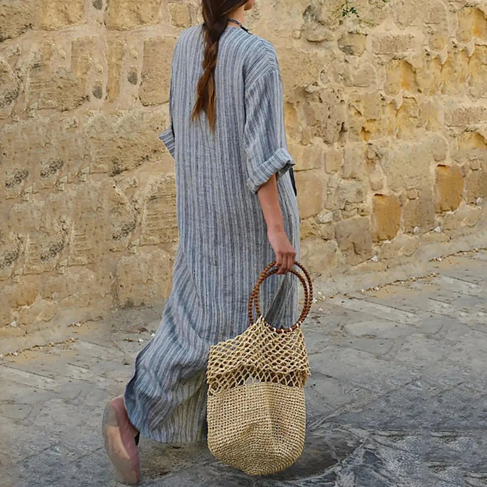 "Striped long-sleeve maxi dress in soft organic cotton blend, featuring a flattering empire waist and elegant design."