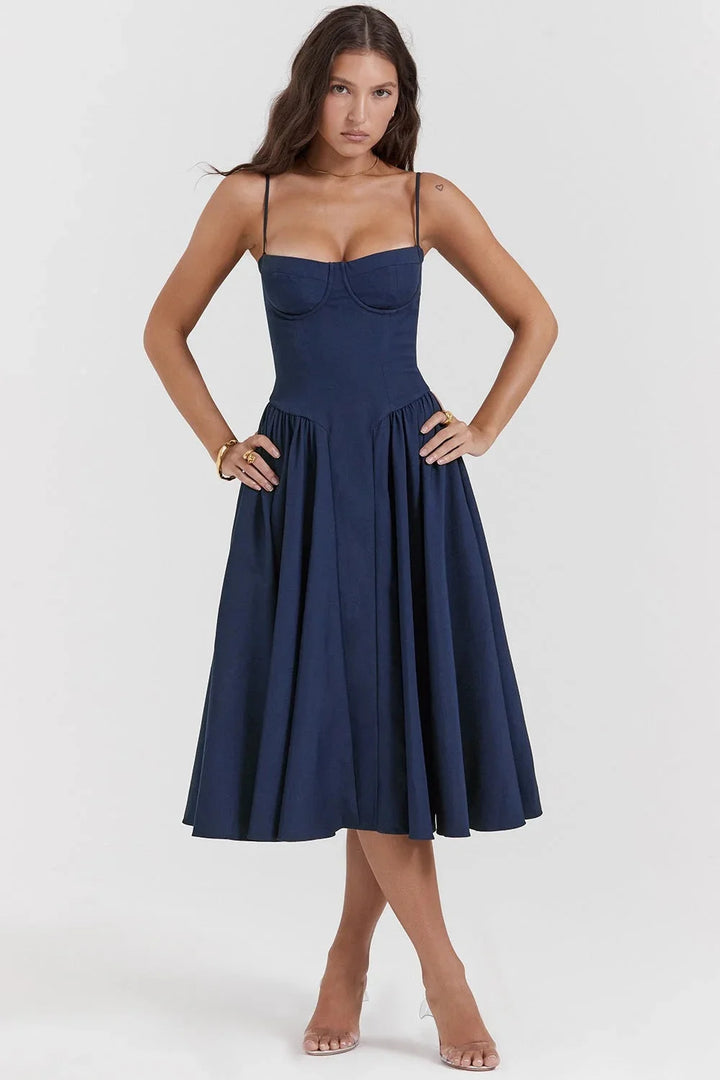 Navy blue fitted bodice dress with flare for women. A sleek design that flatters with a unique pleated detailing.