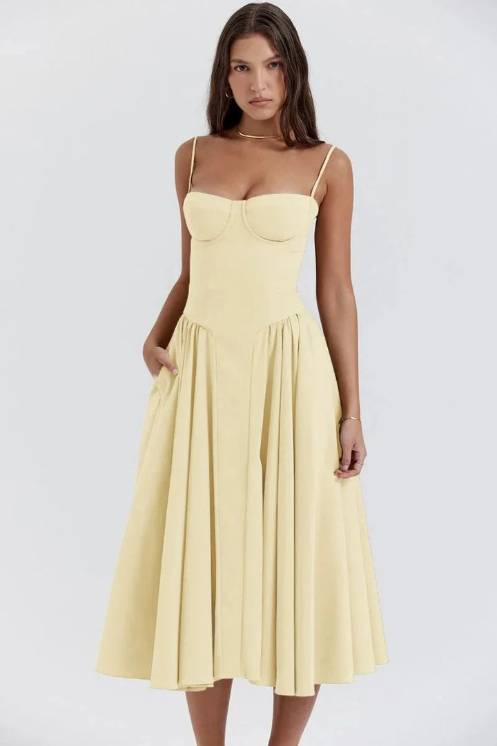 Yellow women's fitted bodice dress with flare design, made of a soft and lightweight fabric. Features a flattering…