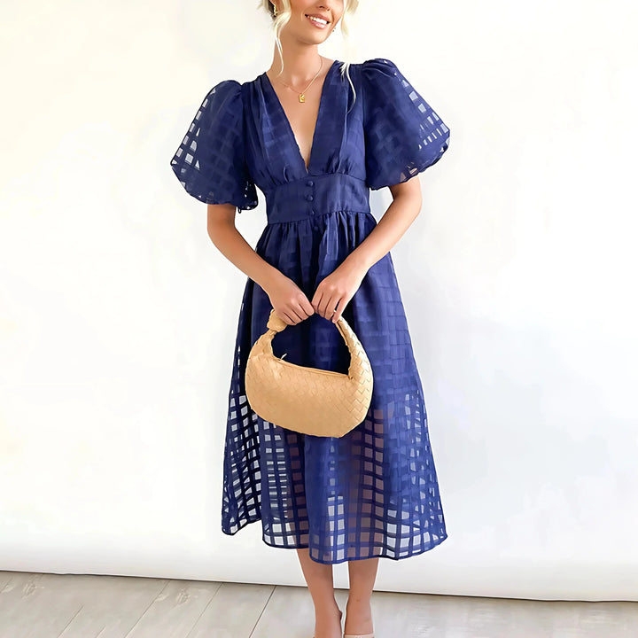 "Navy blue puff-sleeve midi dress with textured fabric for women, elegant design ideal for casual or formal occasions."