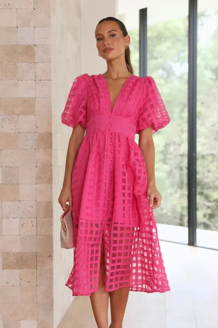 Pink puff-sleeve midi dress for women with textured fabric, a charming choice for any occasion.