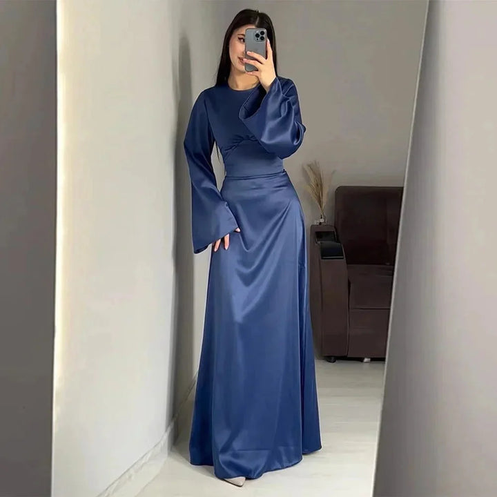 Blue full-length dress for women, featuring elegant sleeves and a tasteful design. Crafted from high-quality fabric.
