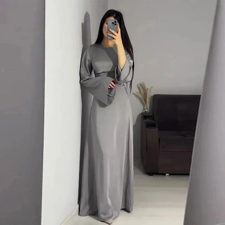 "Gray full-length dress with sleeves for women, elegant design with a subtle pattern, perfect for formal occasions."