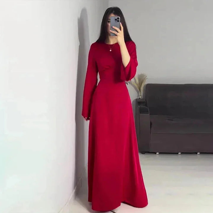 Red full-length dress for women with sleeves. Features elegant design.