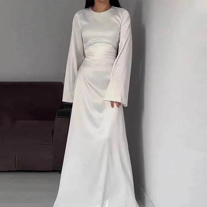 White full-length dress for women named Salome with sleeves. Made from high-quality fabric, elegant design perfect for…