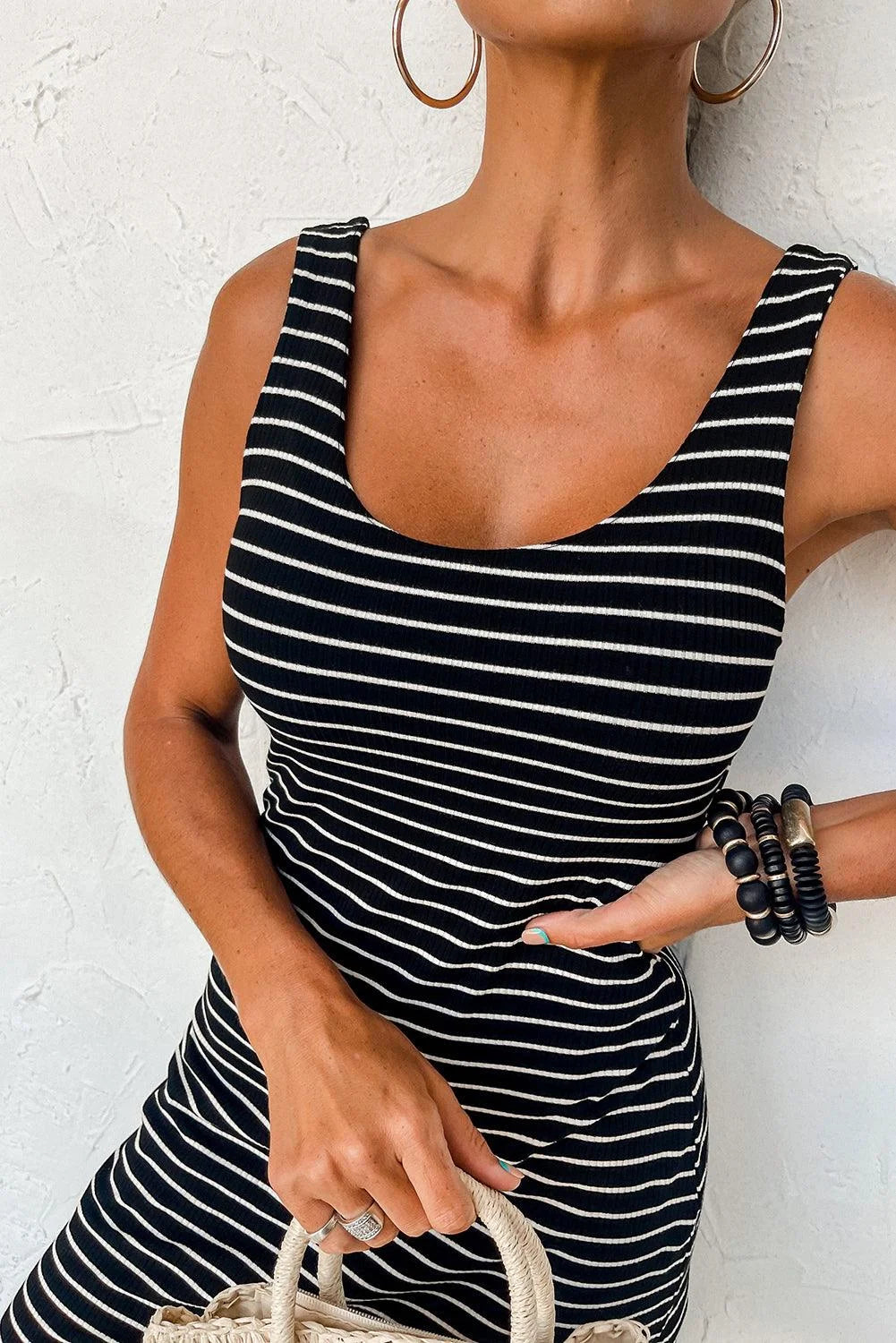 Navy sleeveless dress with white stripes, made of lightweight breathable fabric, perfect for summer outings and casual…