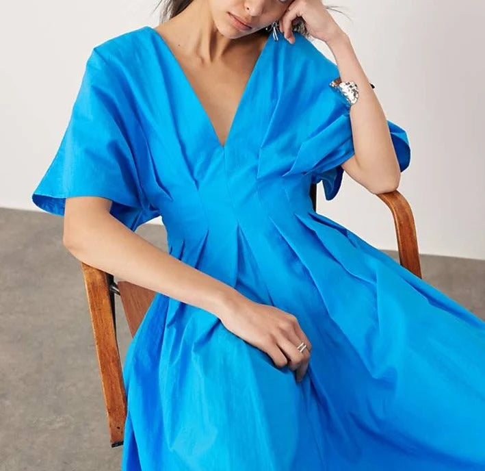 Electric blue midi dress with a flattering V-neck design in a soft and smooth fabric.