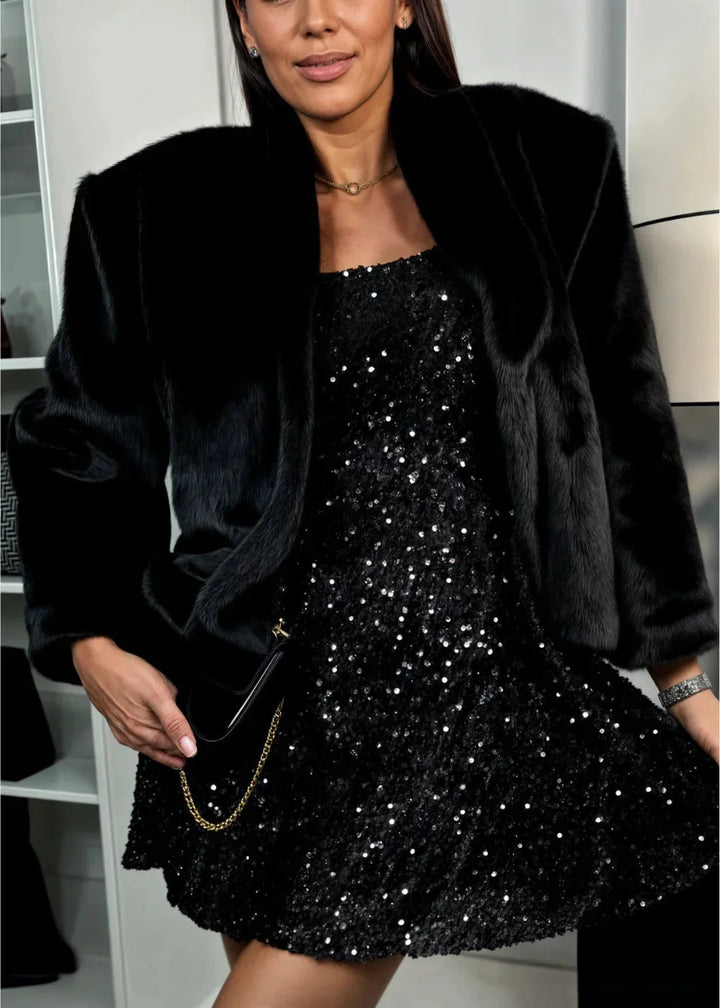 "Black sequined dress with flared sleeves for women, ideal for a glamorous evening look."