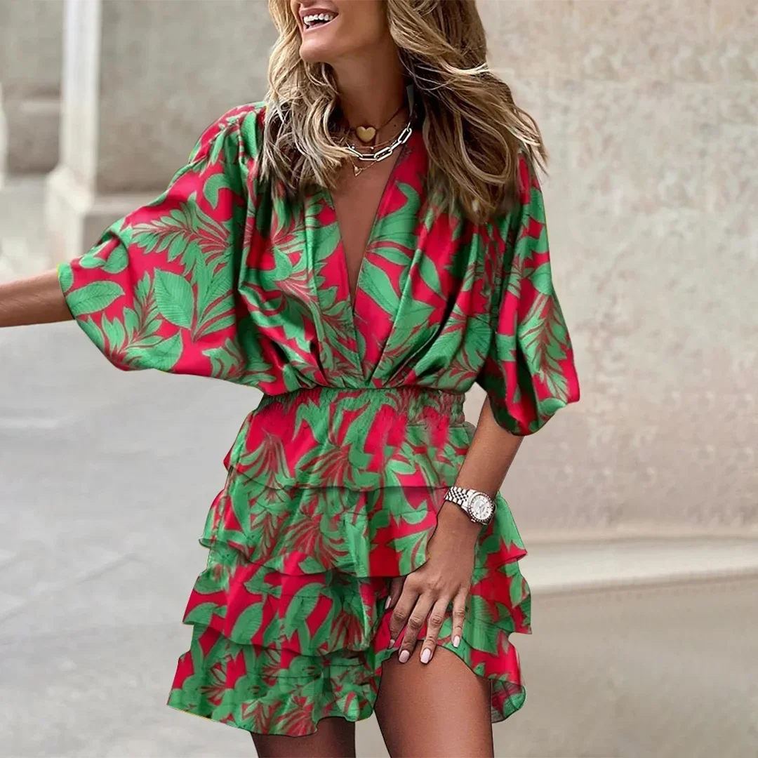 Green floral wrap dress with flared sleeves, ideal for summer, made of lightweight and breathable fabric.