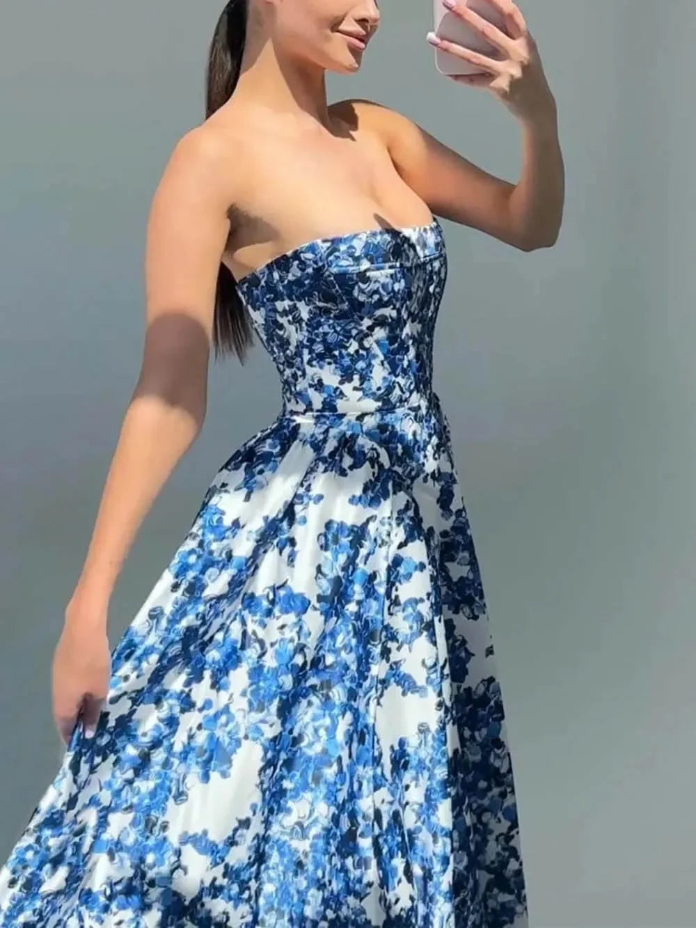 Blue floral strapless maxi dress featuring a breezy design with an elegant floral pattern.