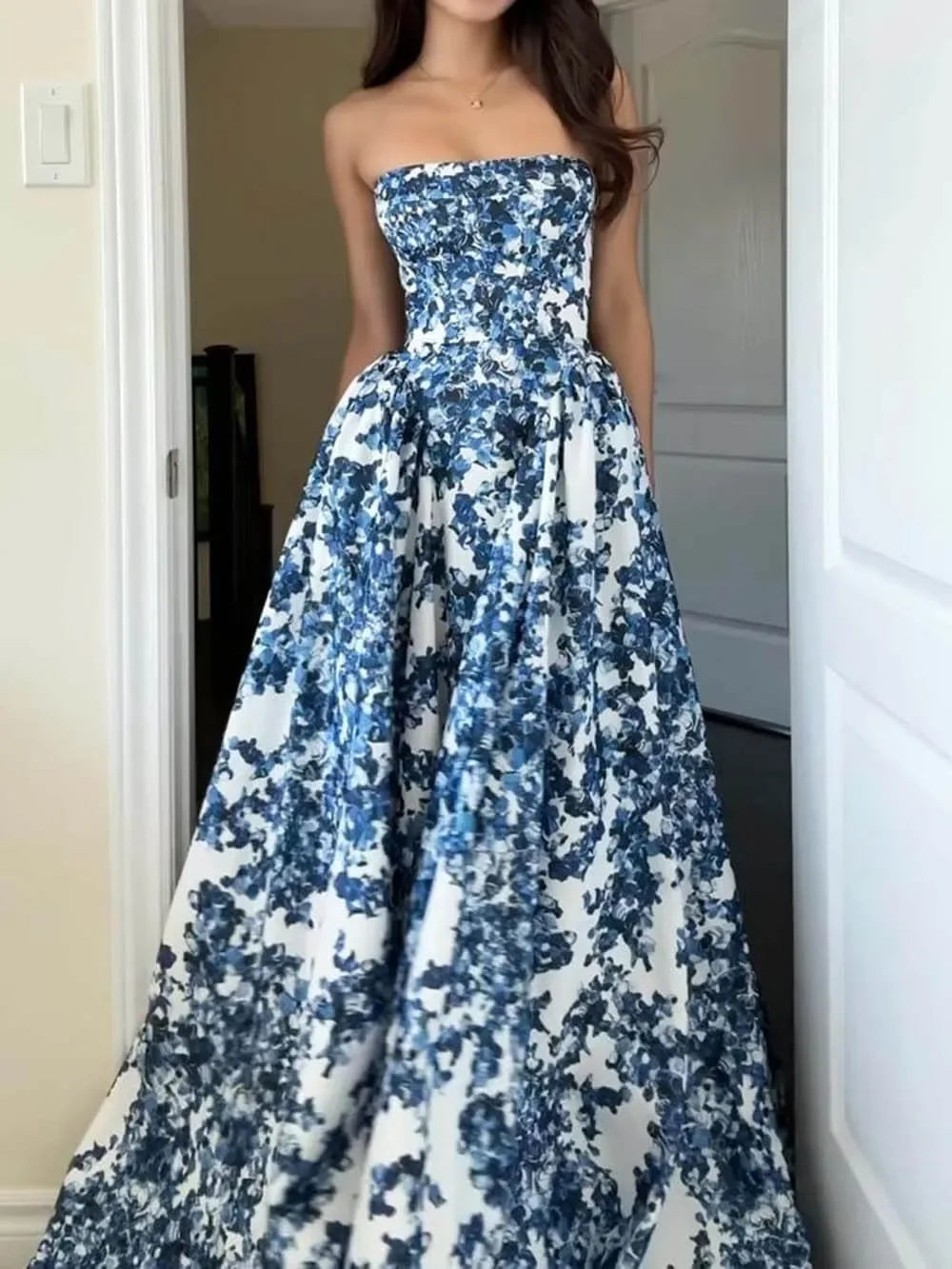 Blue floral strapless maxi dress with a flowy silhouette. Features a colorful floral print on soft, breathable fabric…