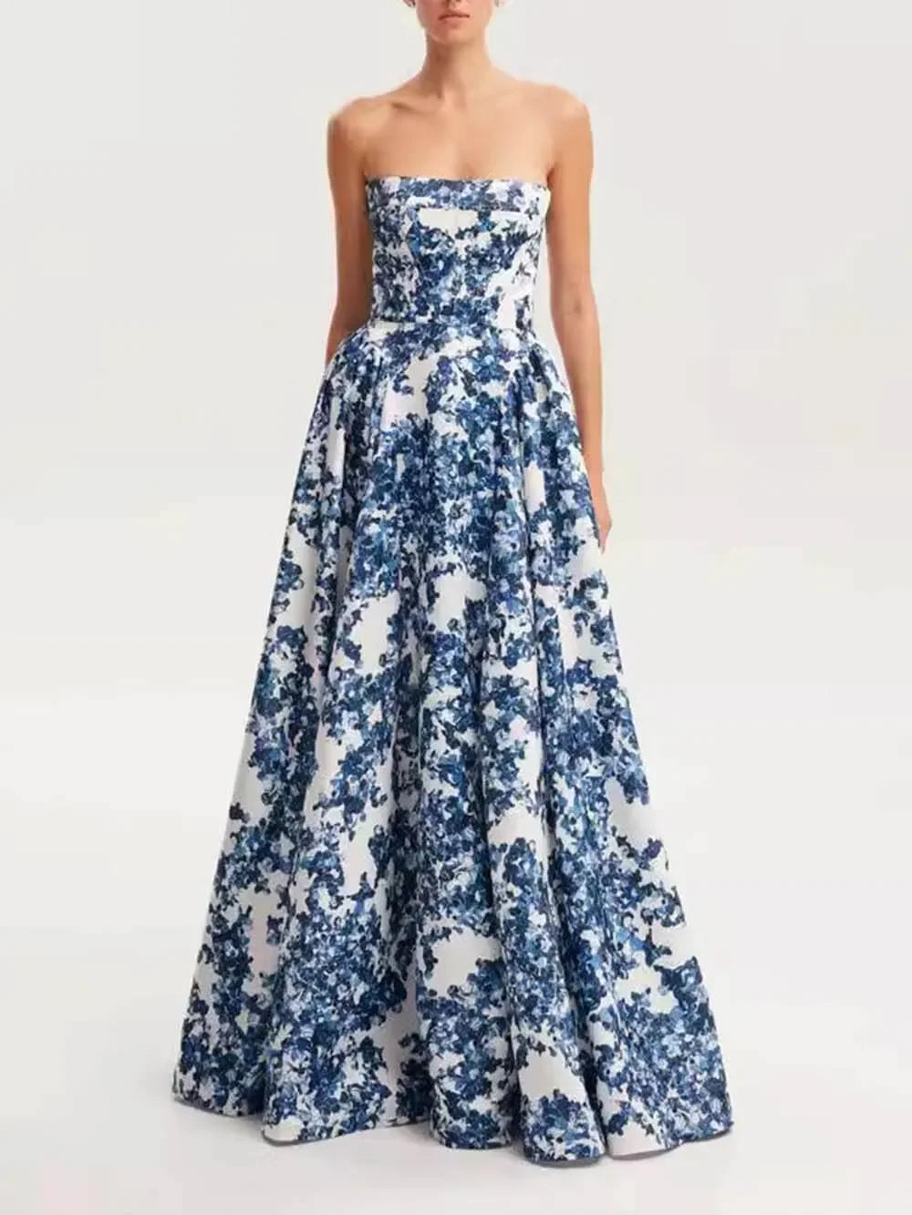 Blue floral strapless maxi dress made of flowy chiffon with a flattering ruched bodice, perfect for a casual summer day or…