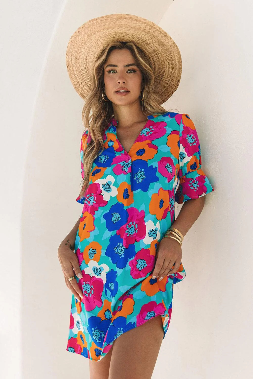 "Vibrant floral design V-neck dress in soft fabric, perfect for summer days."