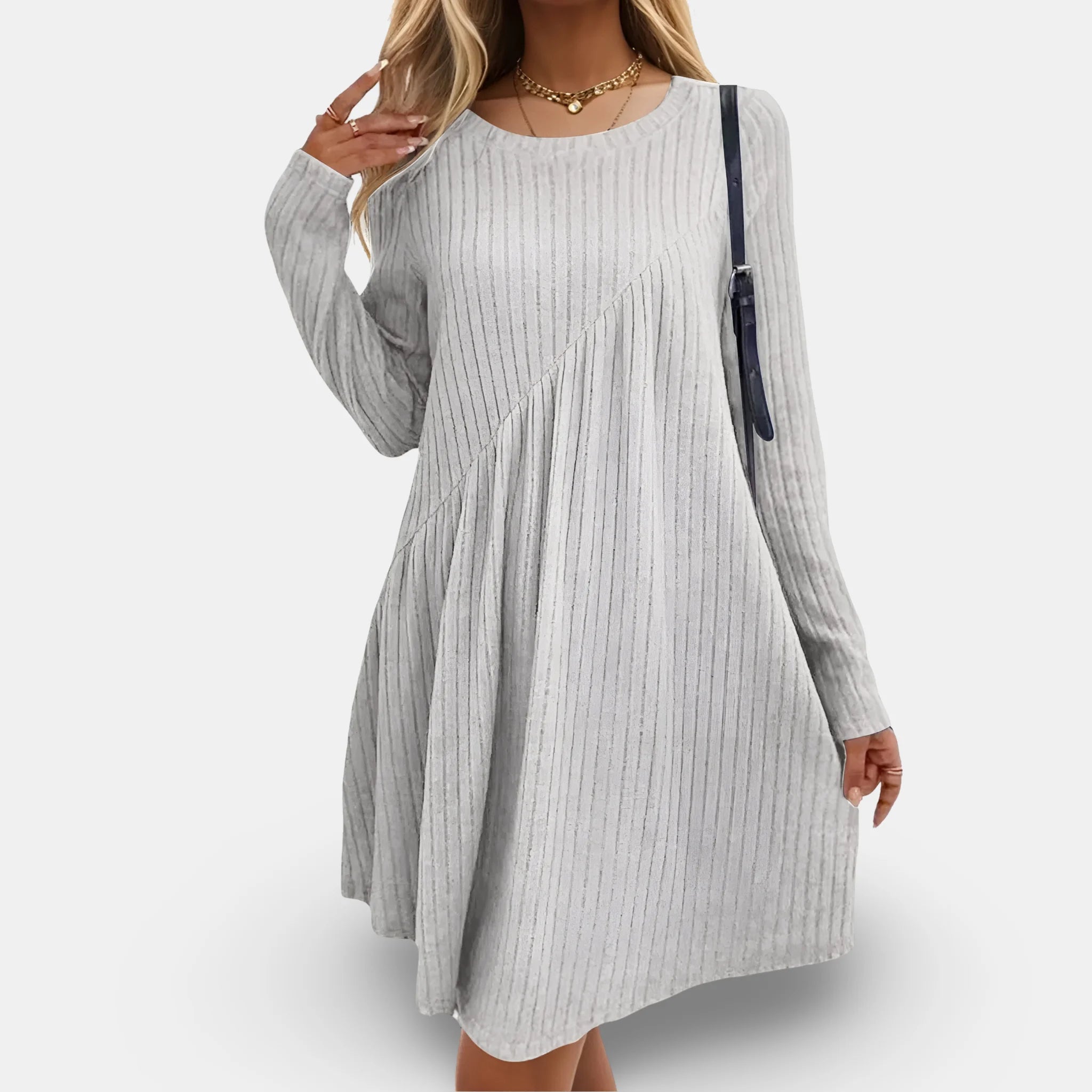 Light grey flowing dress with long sleeves, textured fabric and elegant design.