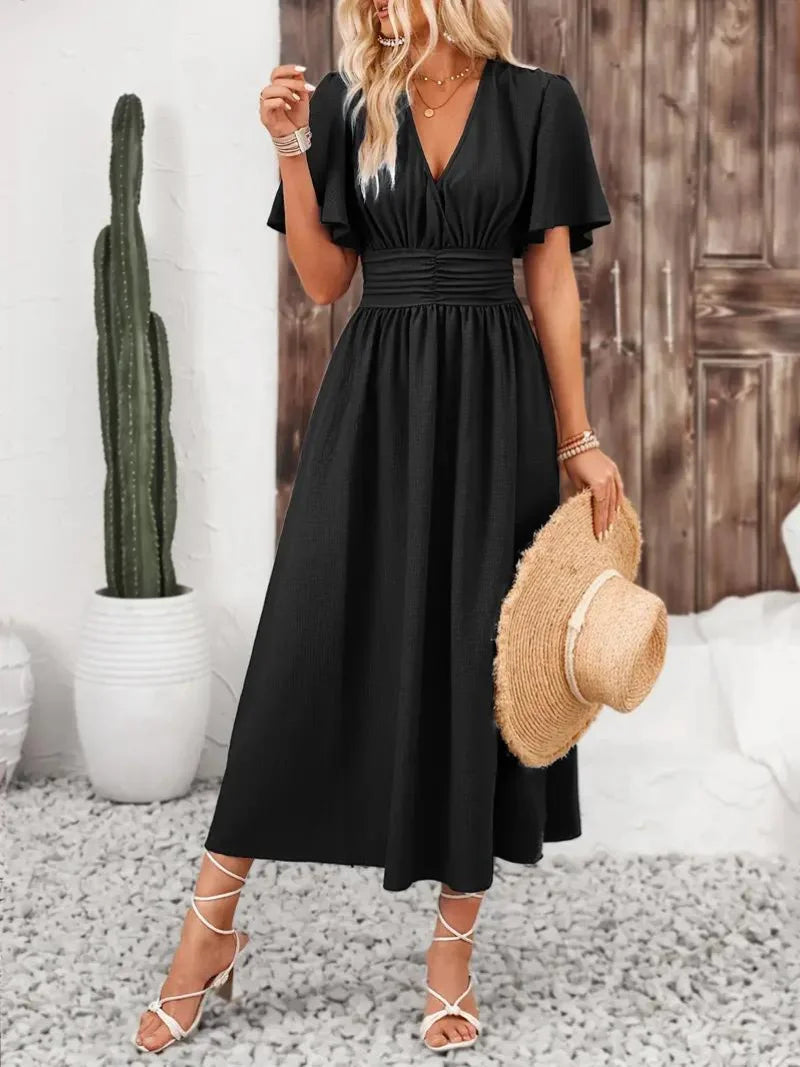 "Black flowy V-neck midi sundress made from lightweight fabric, perfect for summer strolls and casual occasions"