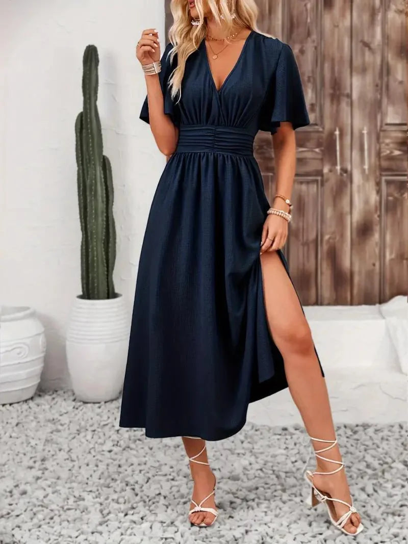 Flowy navy blue V-neck midi sundress, made of breathable fabric. Perfect for summer days or casual outings, with a…