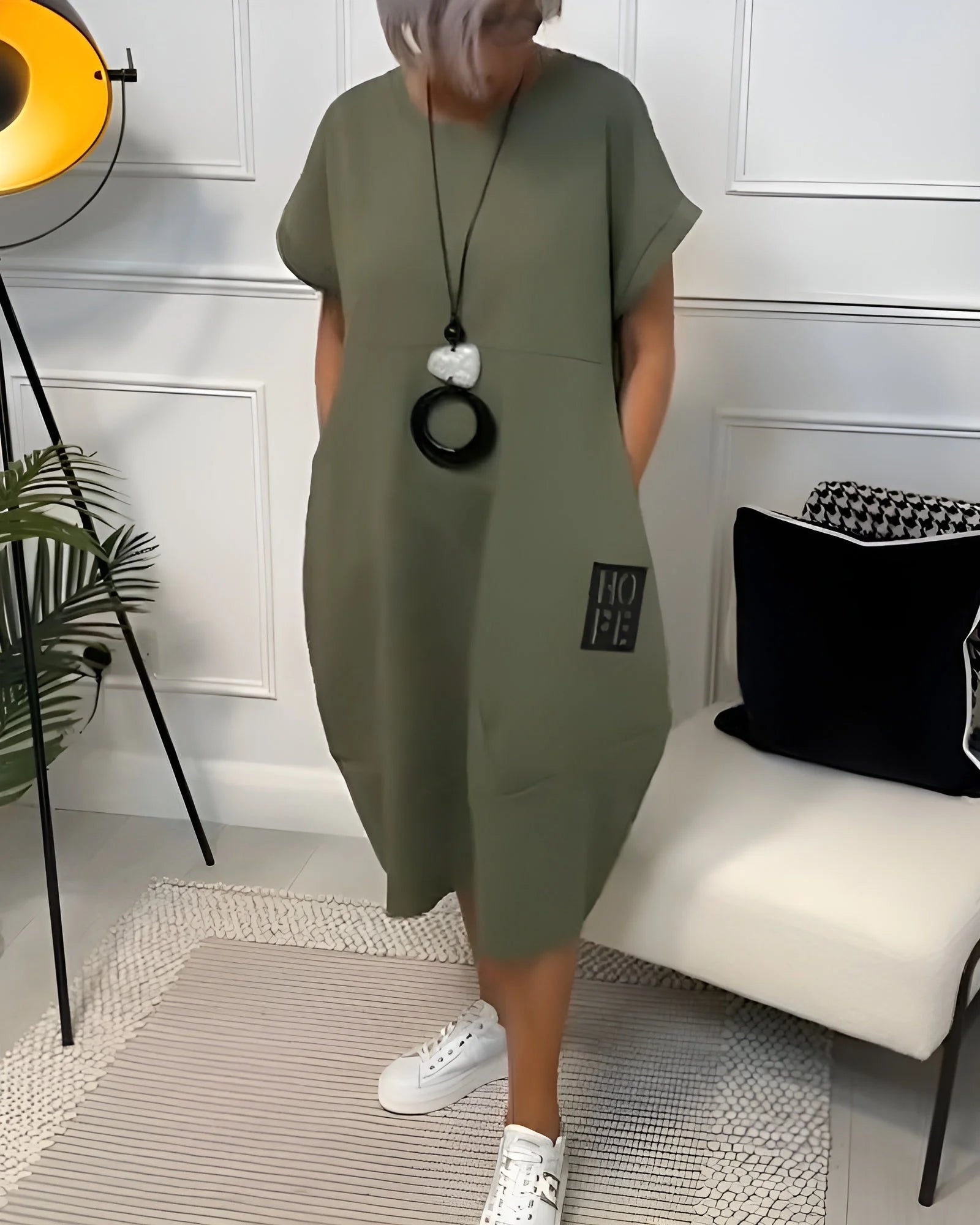 "Green mid-length dress named Wednesday with practical pockets, ideal for everyday wear, made from soft and comfortable…