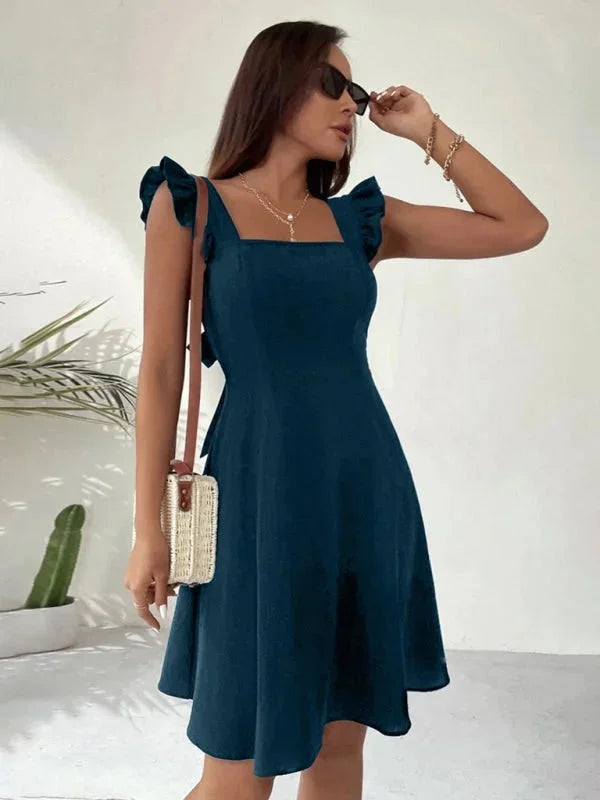 Women's fitted dress in black with ruffle straps, made from comfortable stretch fabric, perfect for a chic and stylish look.