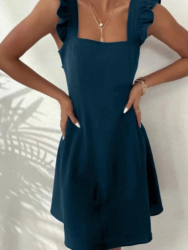 "Navy women's fitted dress with ruffle straps, made from soft, stretchy fabric, perfect for casual or dressy occasions."