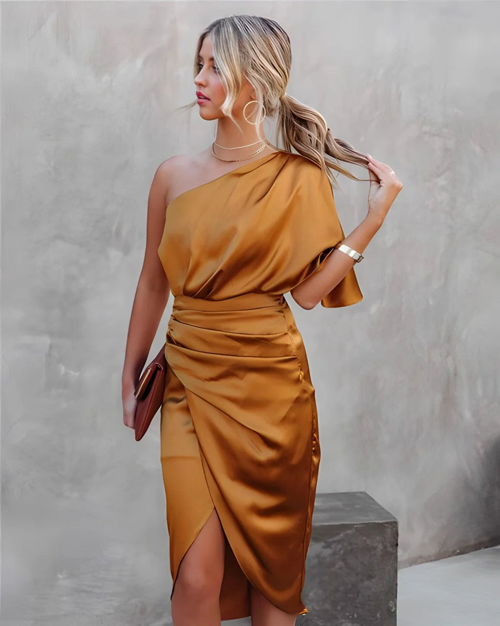 Orange one-shoulder sundress with asymmetrical hem, made of breezy lightweight fabric perfect for summer.