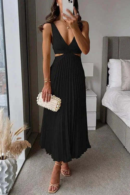 Black pleated dress with side cut-outs, perfect for a chic look.