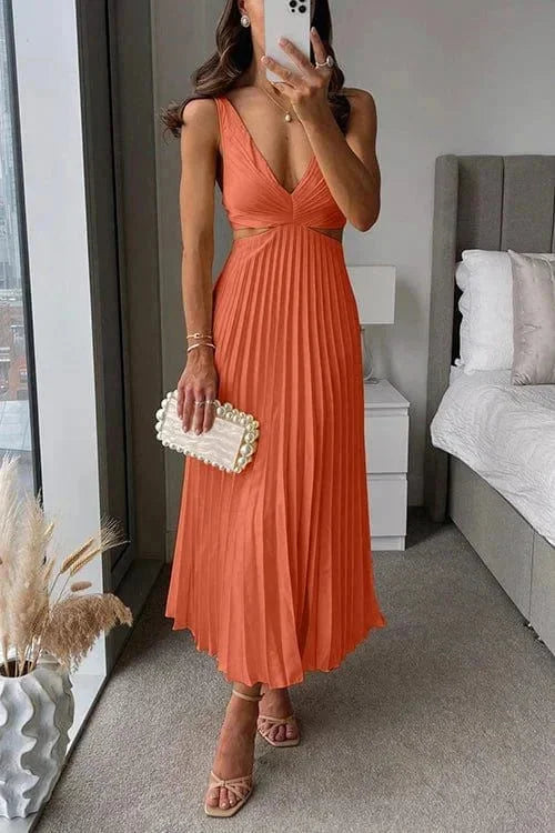 "Orange pleated dress for women featuring side cut-outs, perfect for a summer day out."