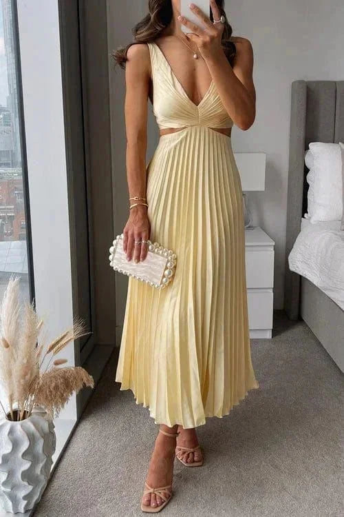Yellow pleated dress with side cut-outs for women by Yulissa. Flowy and elegant design in a vibrant hue perfect for any…